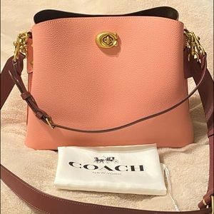 Coach bag style No C2590 Candy pink color it has feet on the bottom very clean